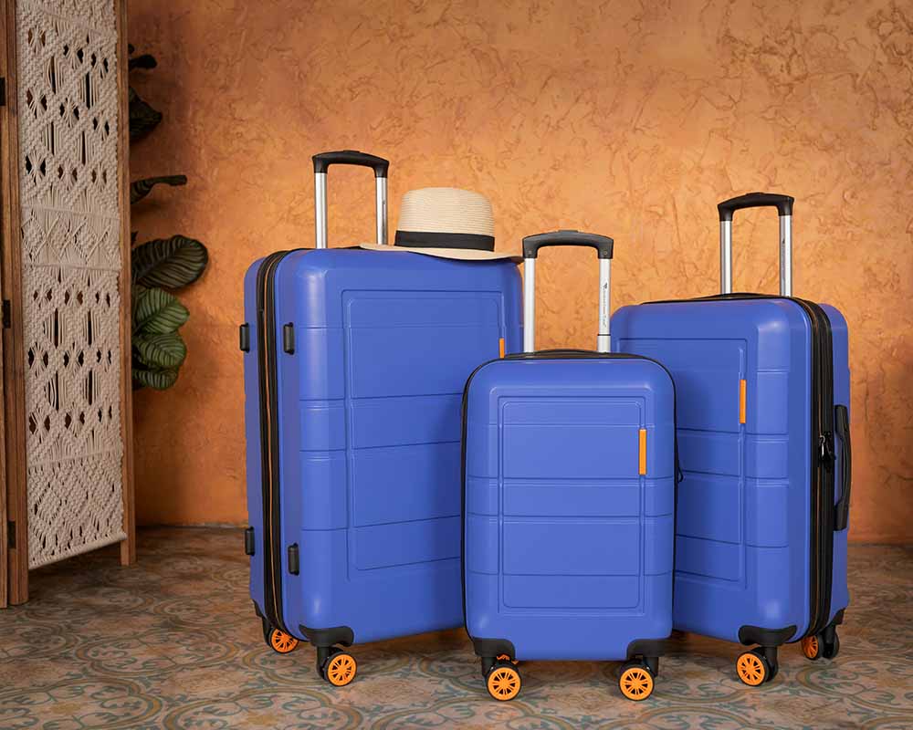 blue luggage set in hotel room