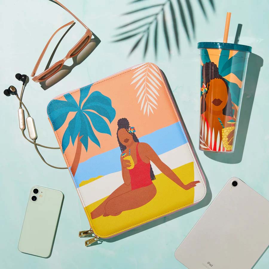 Beachside Travel Zippered Techfolio surrounded by a water tumbler, sunglasses, earphones, cell phone and tablet