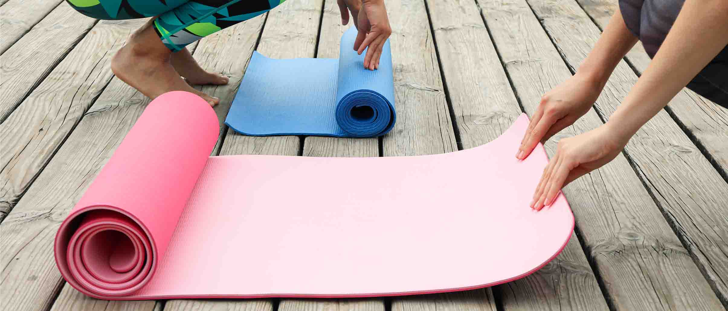 Image of people rolling out yoga mats