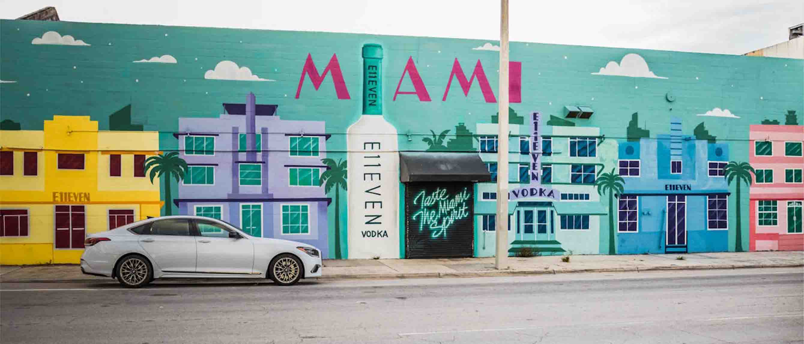 a car driving by a colorful street inn Miami, Florida 