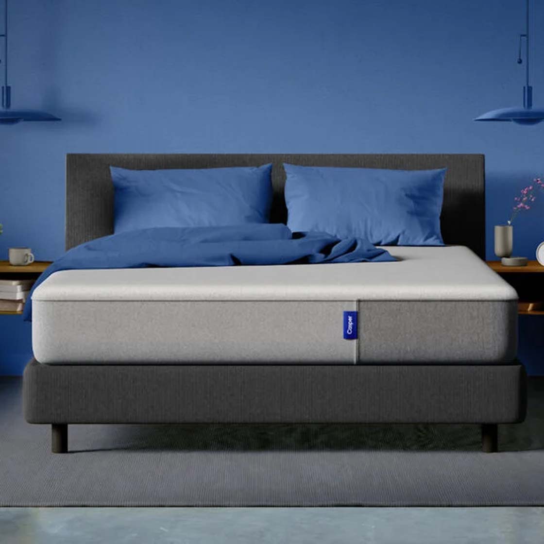 The Casper Mattress on a bed frame with two pillows
