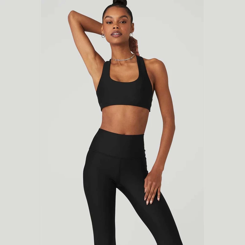 model wearing Alo Yoga Airlift Advantage Racerback Bra in black with matching leggings