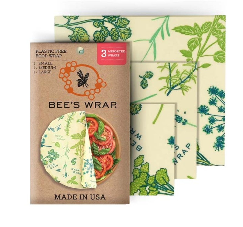 A box of Bee's Wrap and different size wraps with plant print behind 