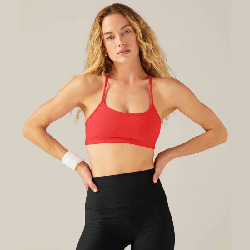 model wearing Spacedye Slim Racerback bra in red with black leggings 