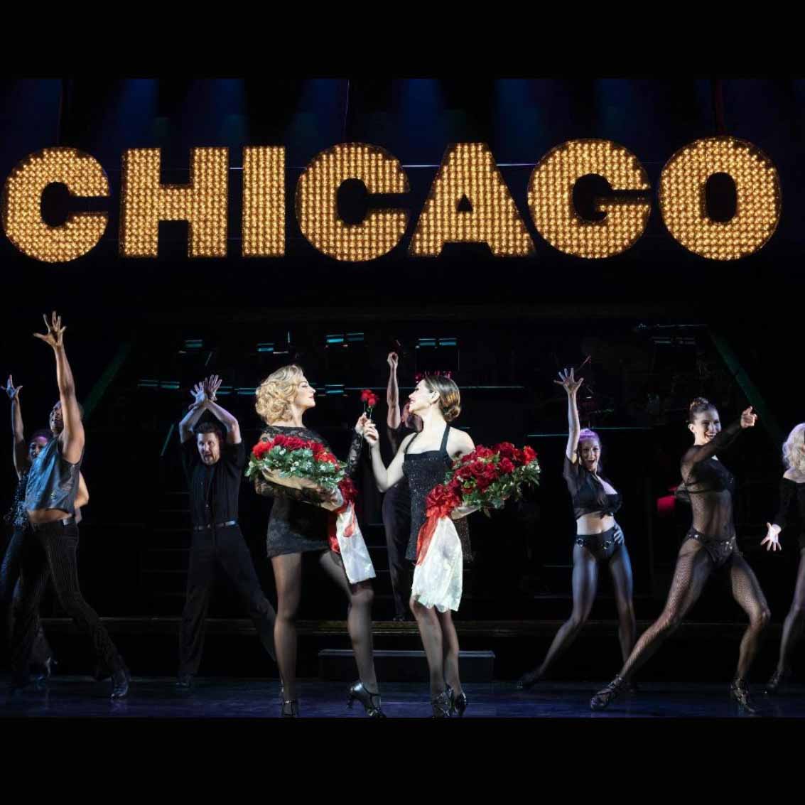 A scene from Chicago on Broadway with the main characters holding bouquets of roses 