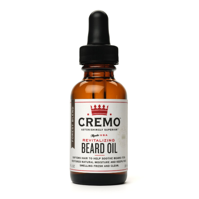 Amber bottle of Cremo Beard Oil with dropper cap