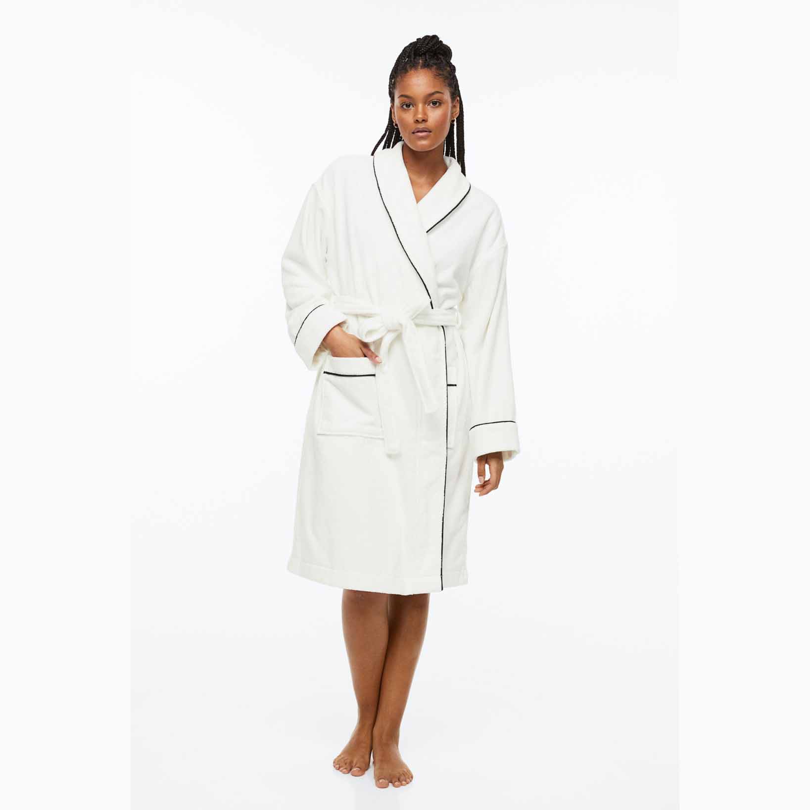 woman wearing long white bathrobe with black lining
