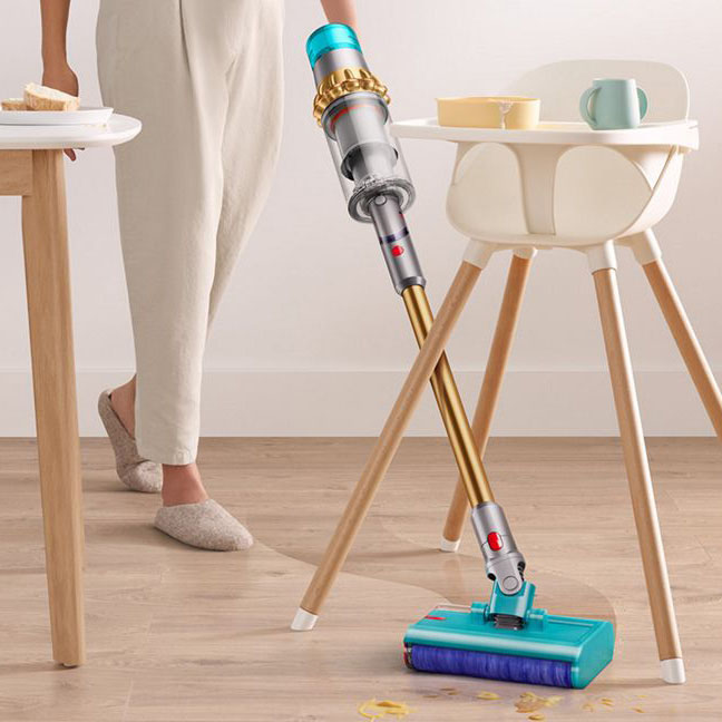 Women using Dyson vacuum to clean hardwood floor