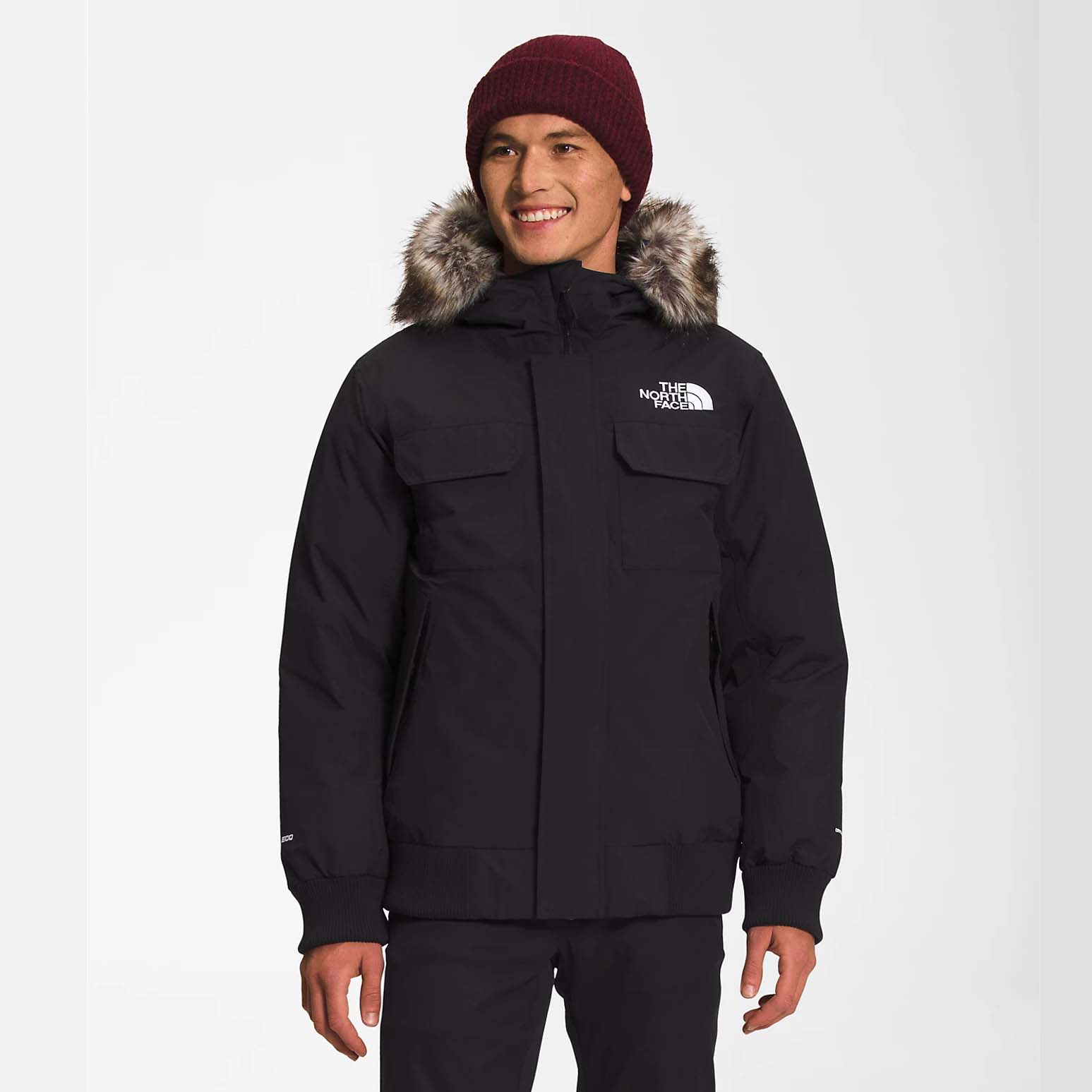 man wearing The North Face Men’s McMurdo Bomber in black with a red beanie