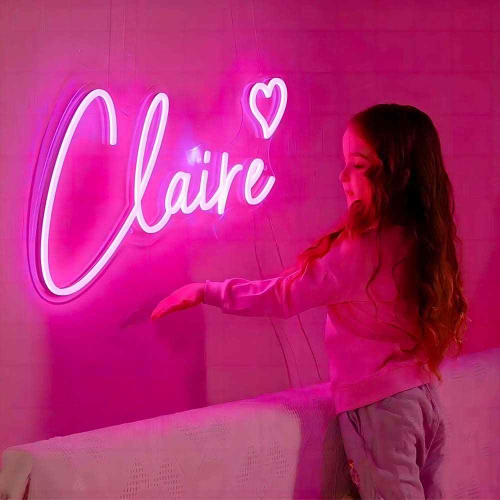 little girl looking at personalised neon sign