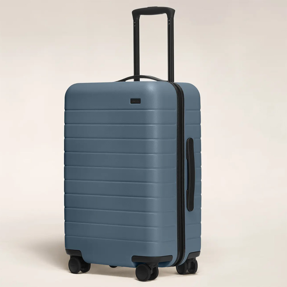 a blue hardshell suitcase with the handle partially extended