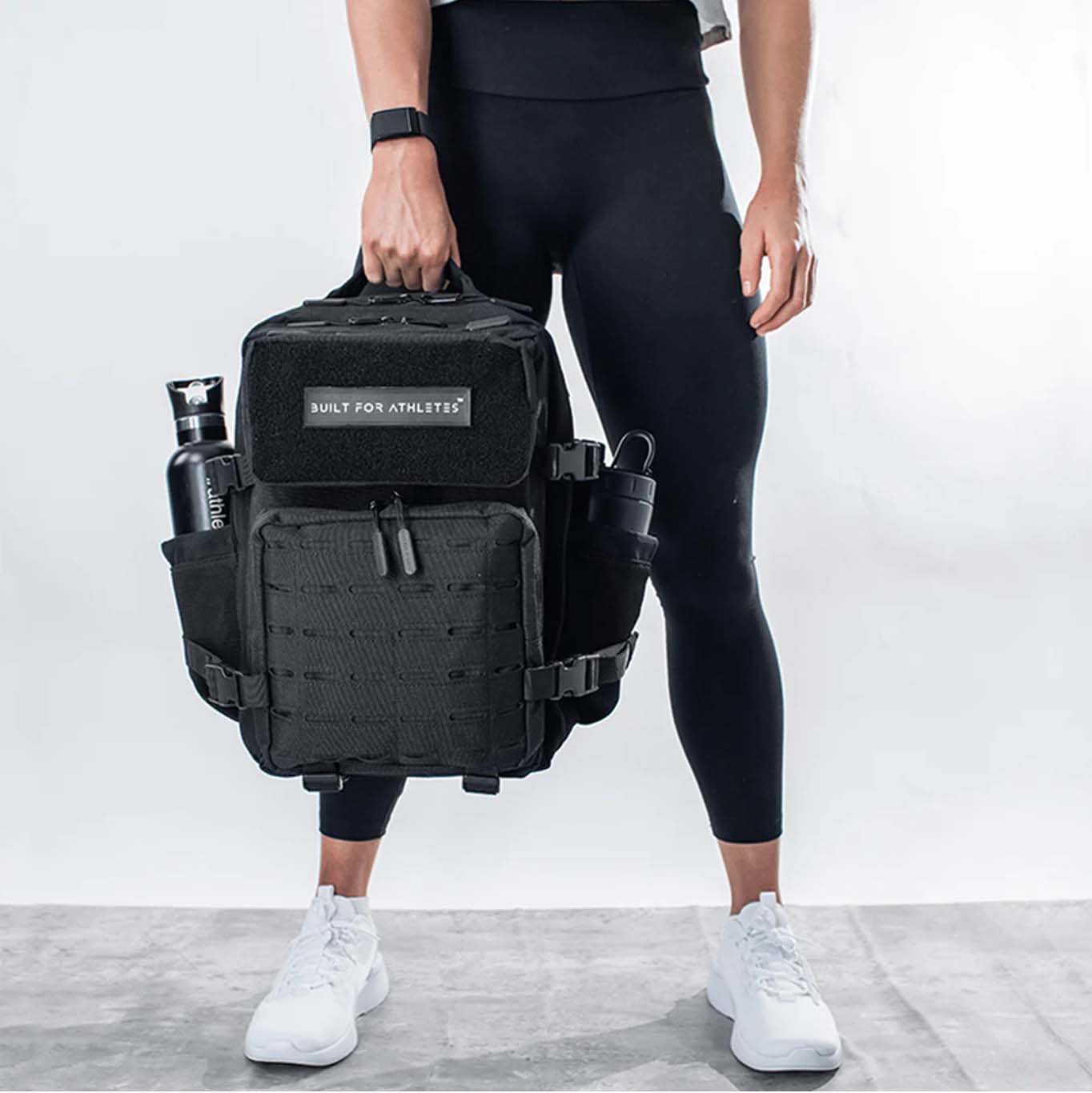 Image of man holding black gym backpack