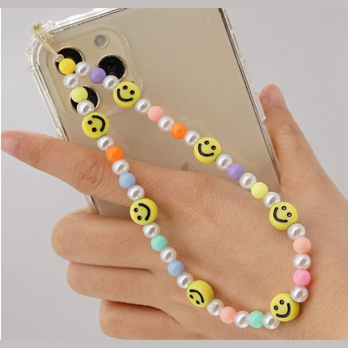 Hand holding a mobile phone with a SYSUII Beaded Mobile Phone Lanyard Wrist Strap