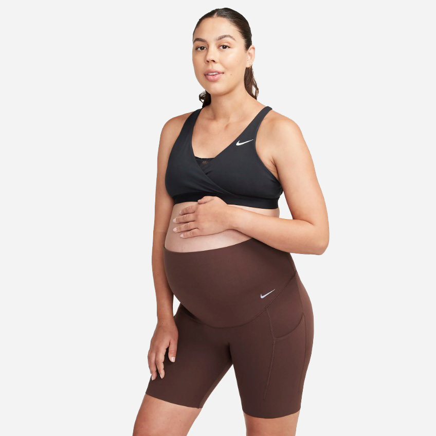 Image of pregnant woman wearing Nike bike shorts in brown