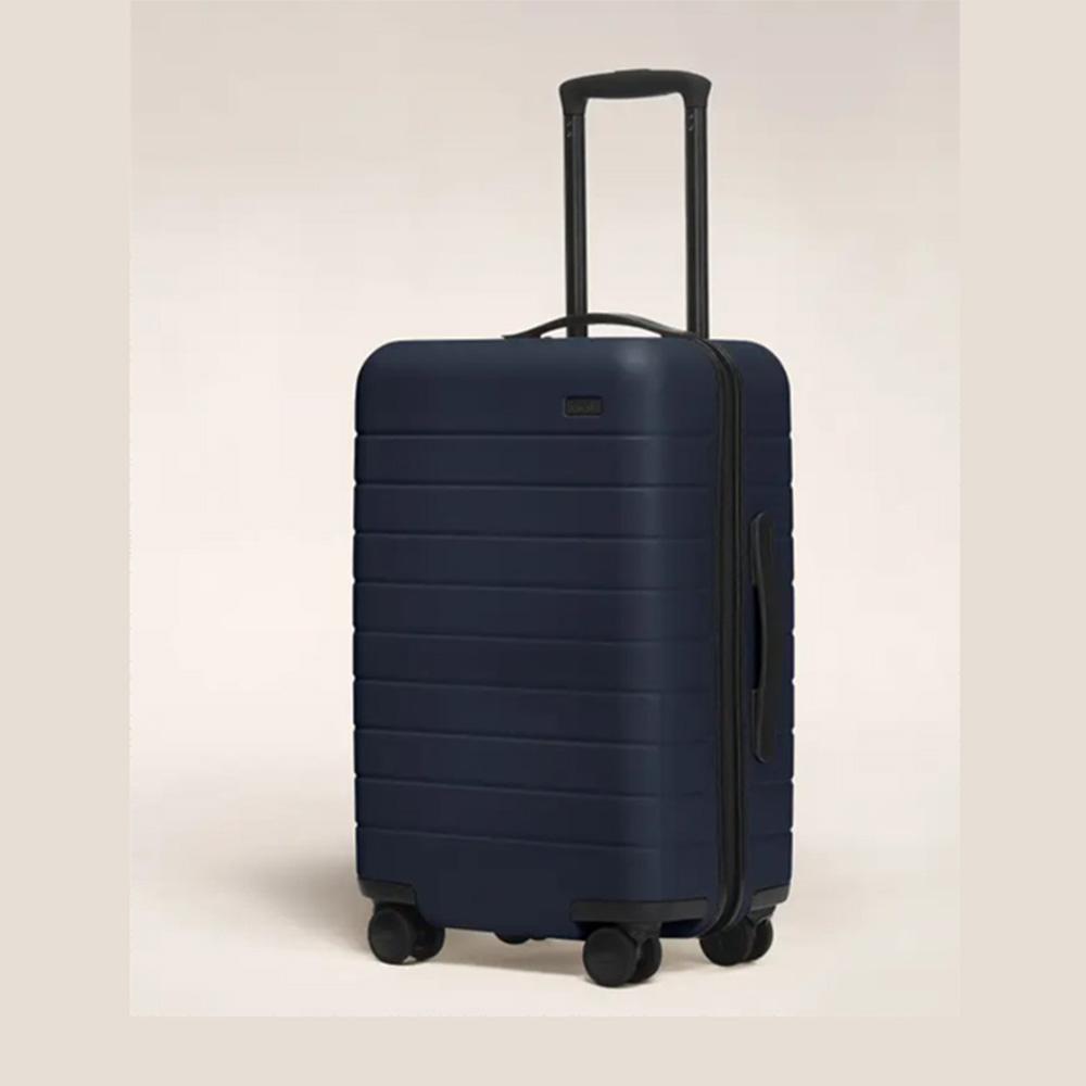 small navy hard shell suitcase with black handles and wheels