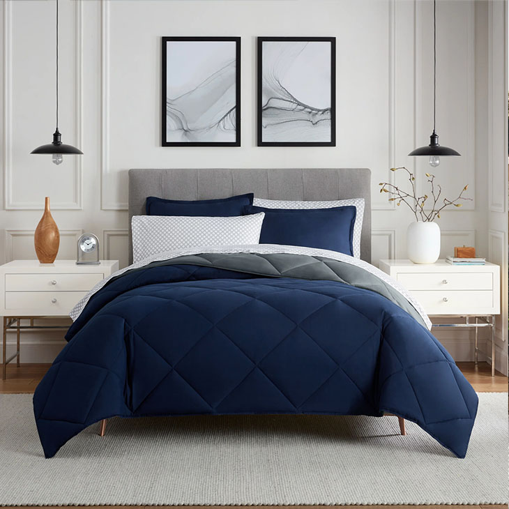 Dark blue and white bedding in bedroom setting