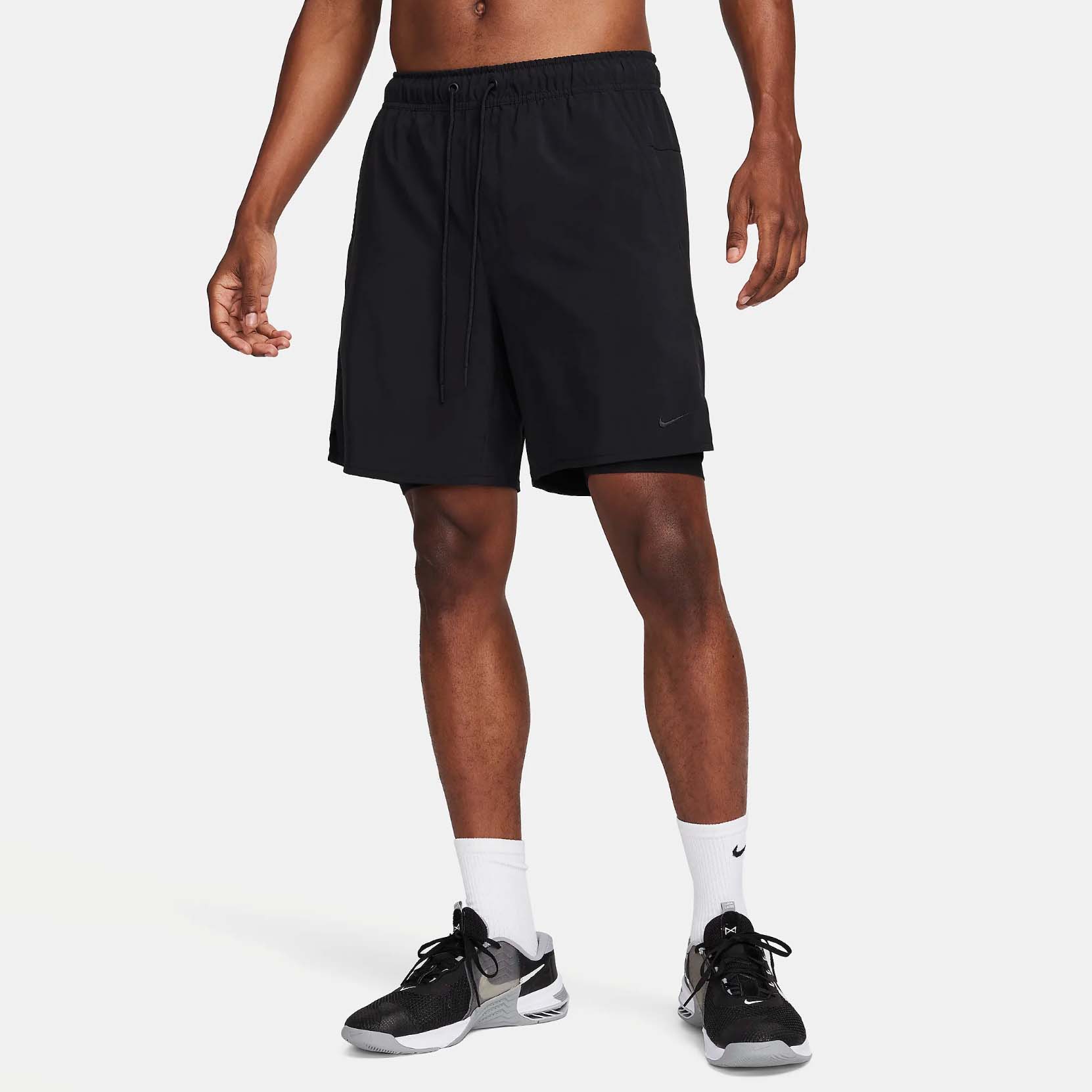 Shirtless man in black gym shorts