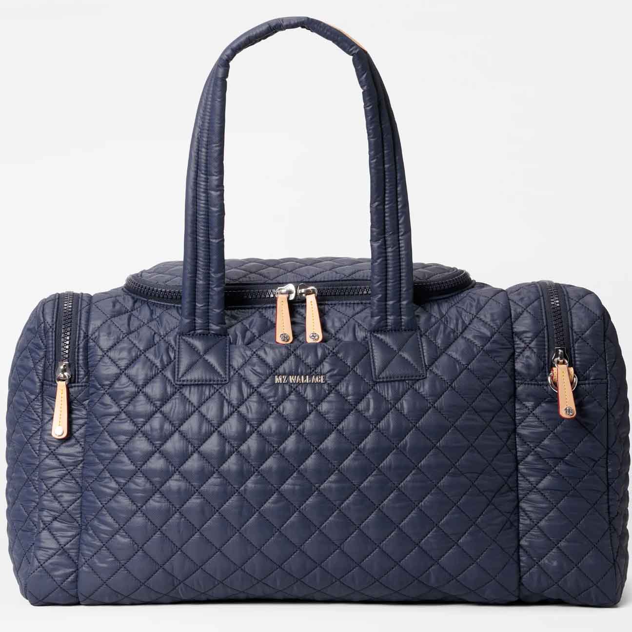 Dark blue duffle bag with gold zippers