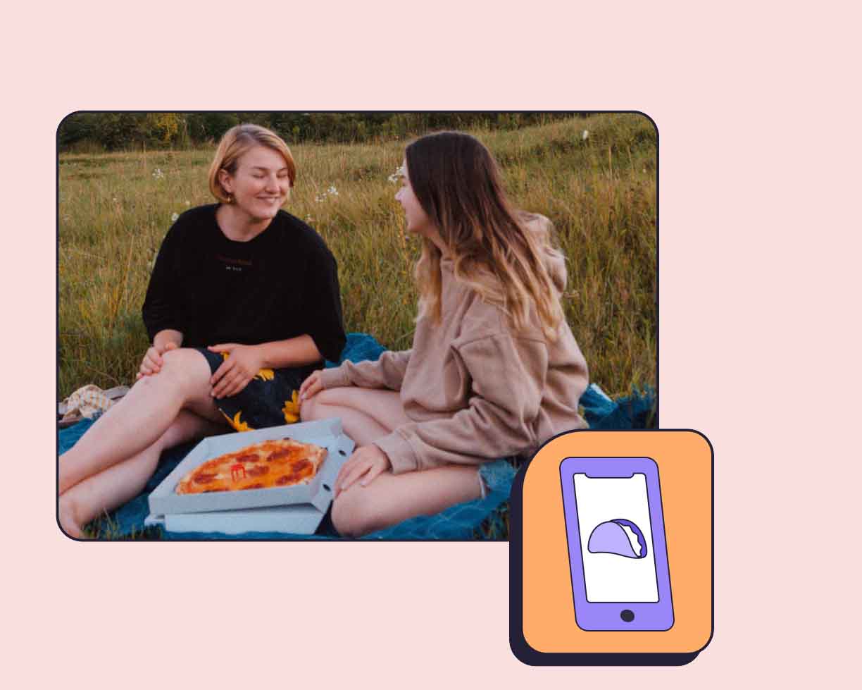 two girls eating outside on a pizza after using DashPass Student perk