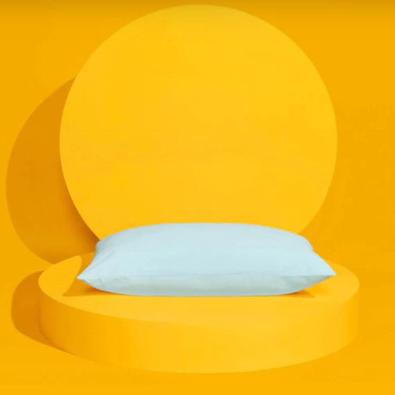 White pillow with yellow background