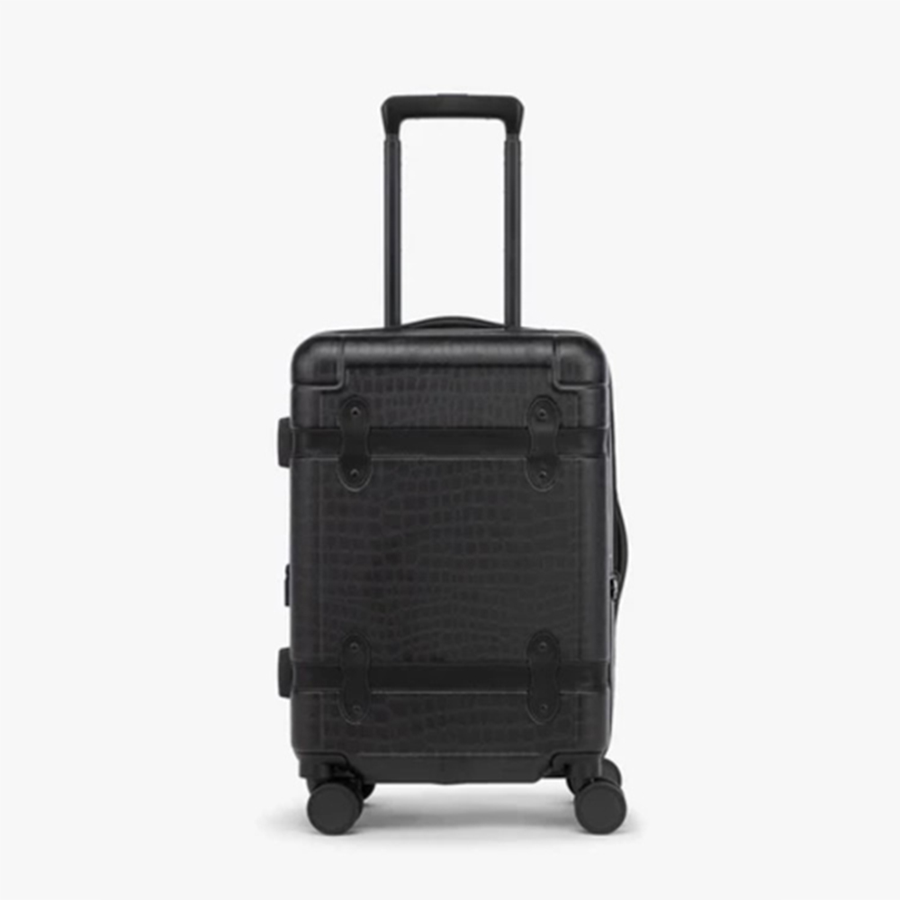 small hard shell black Calpak suitcase