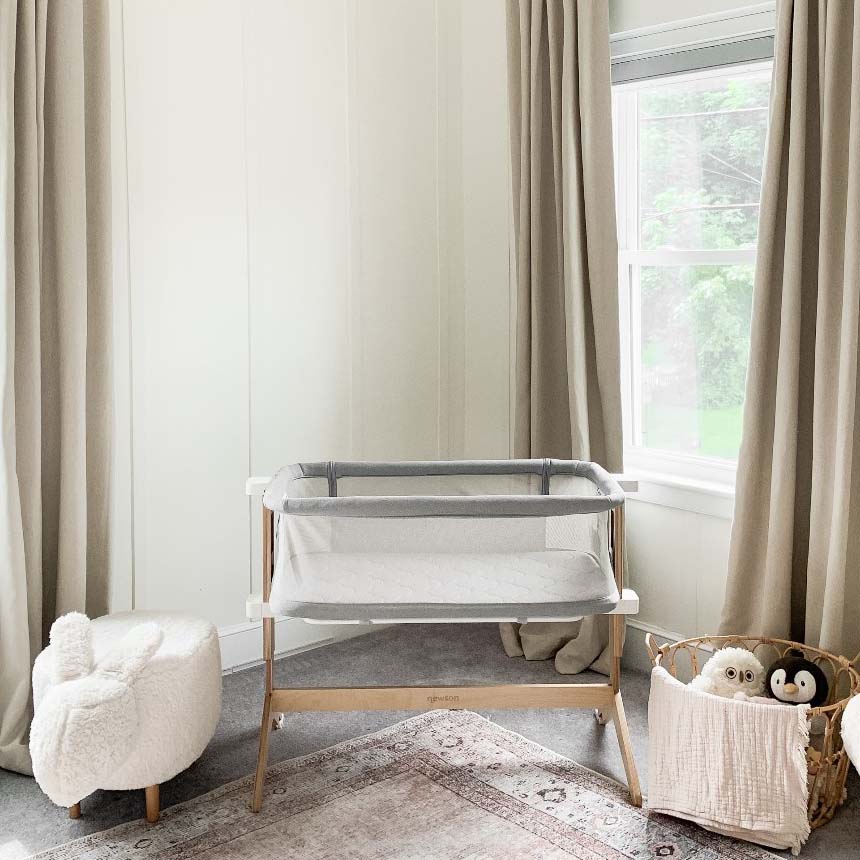 Grey bassinet in room setting