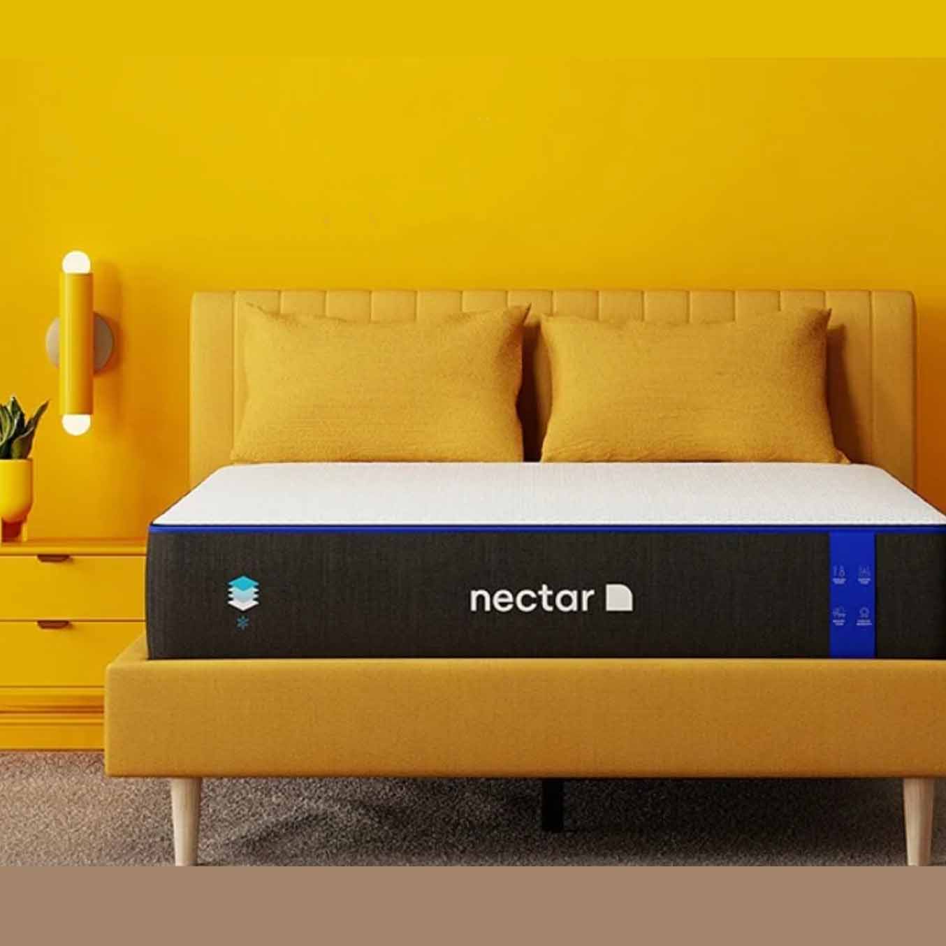 Nectar memory foam mattress on a yellow bed frame and yellow wall