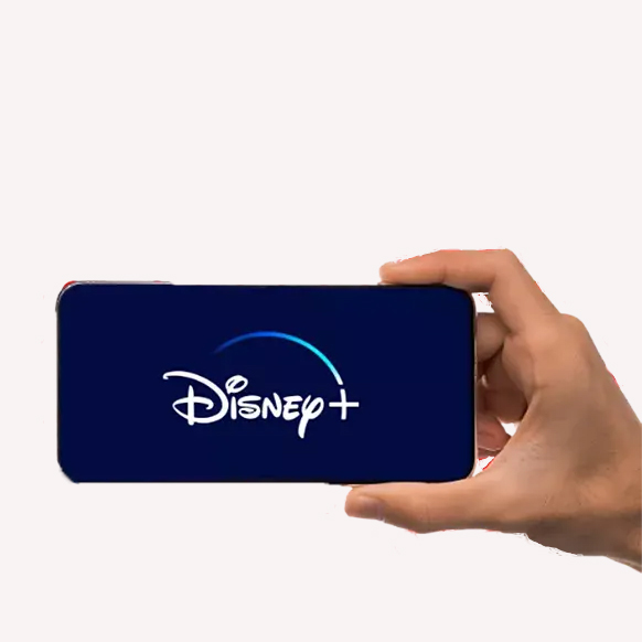 Hand holding a smartphone with words Disney + on it against an off white background