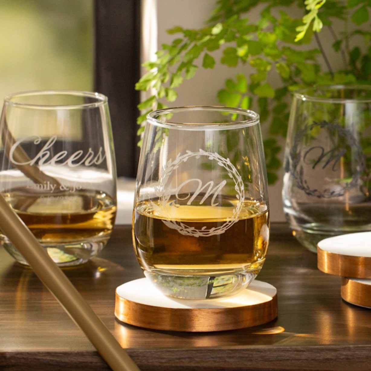 three printed stemless wine glasses