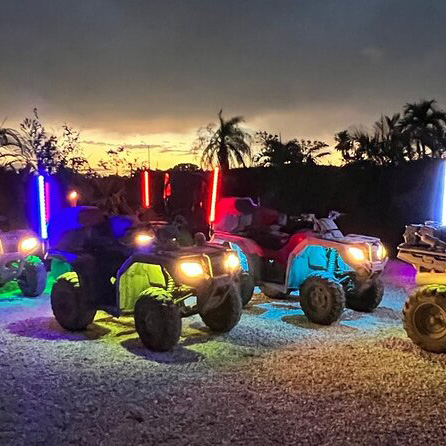 ATVs in a group with neon lights at Night ATV Miami