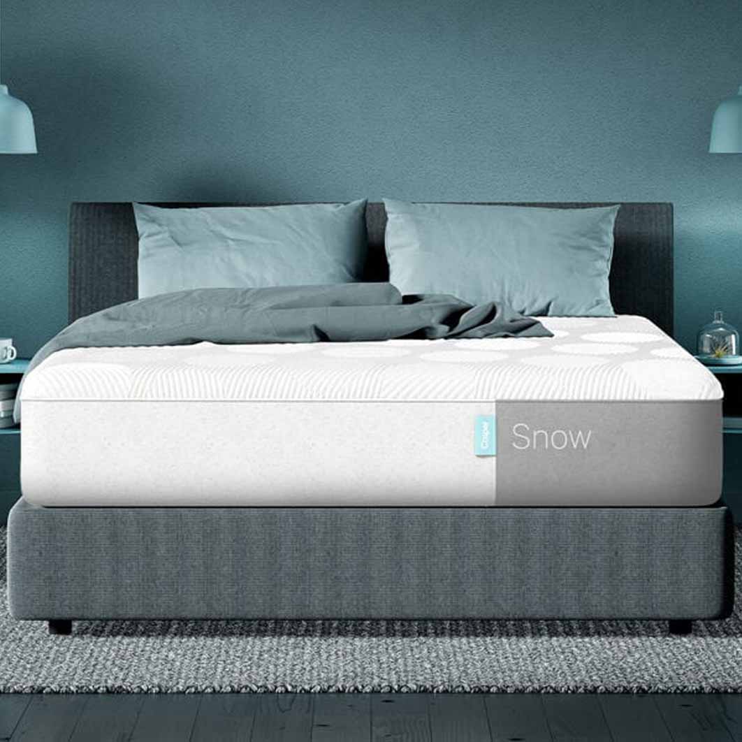 snow mattress from casper on a grey bed frame and two pillows
