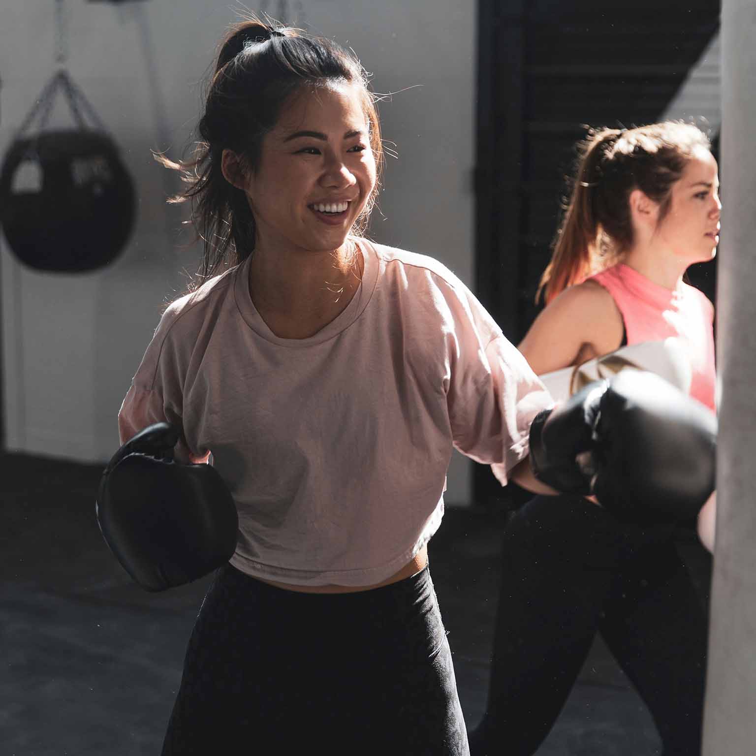 Girl boxing with boxing gloves and smiling