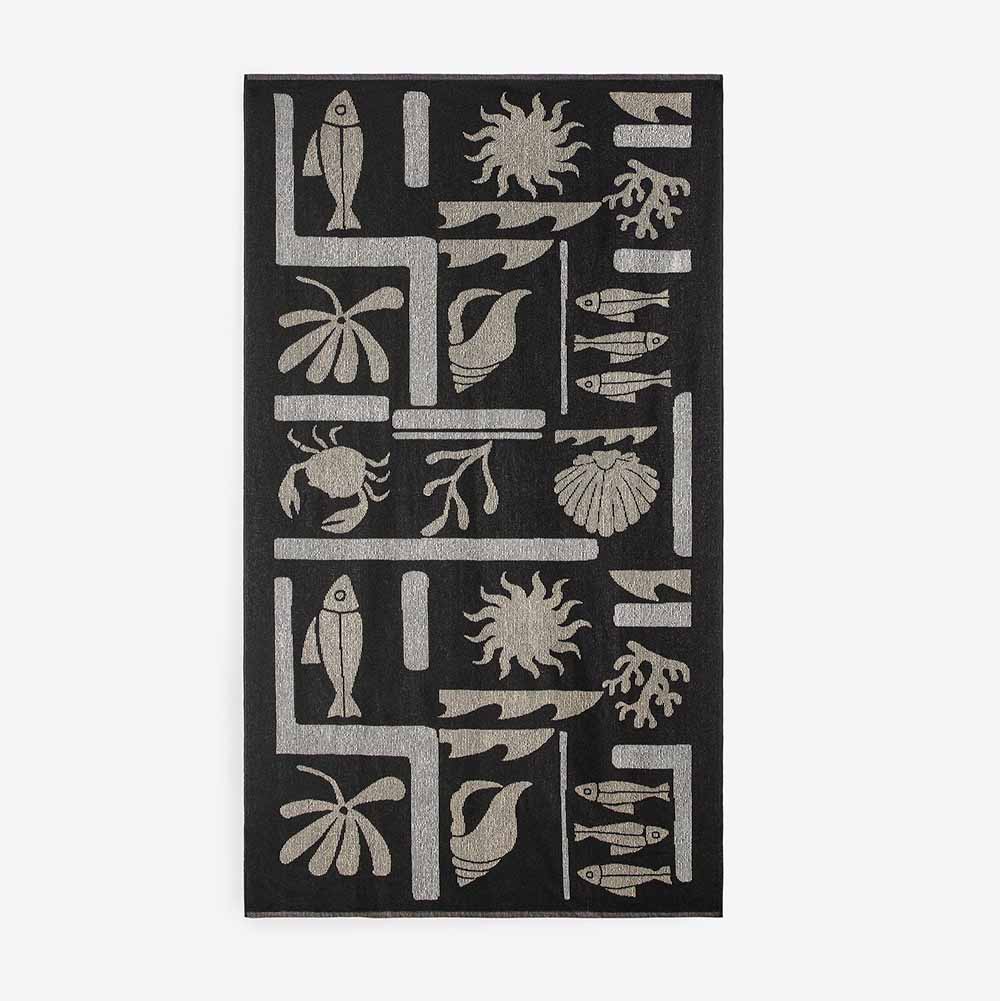 the Contrasting Jacquard Beach Towel in black and beige with abstract nautical design