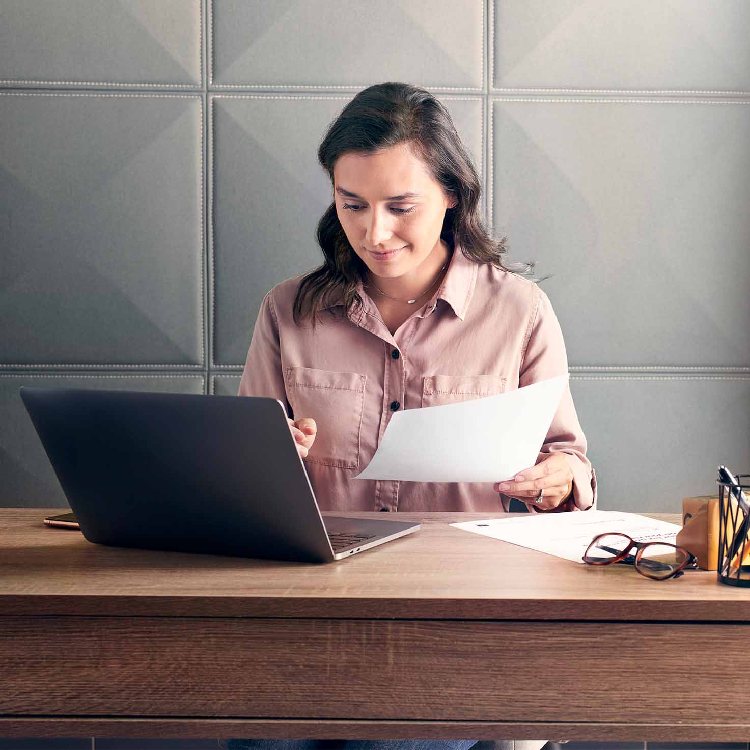 woman filing her taxes on her laptop in home office