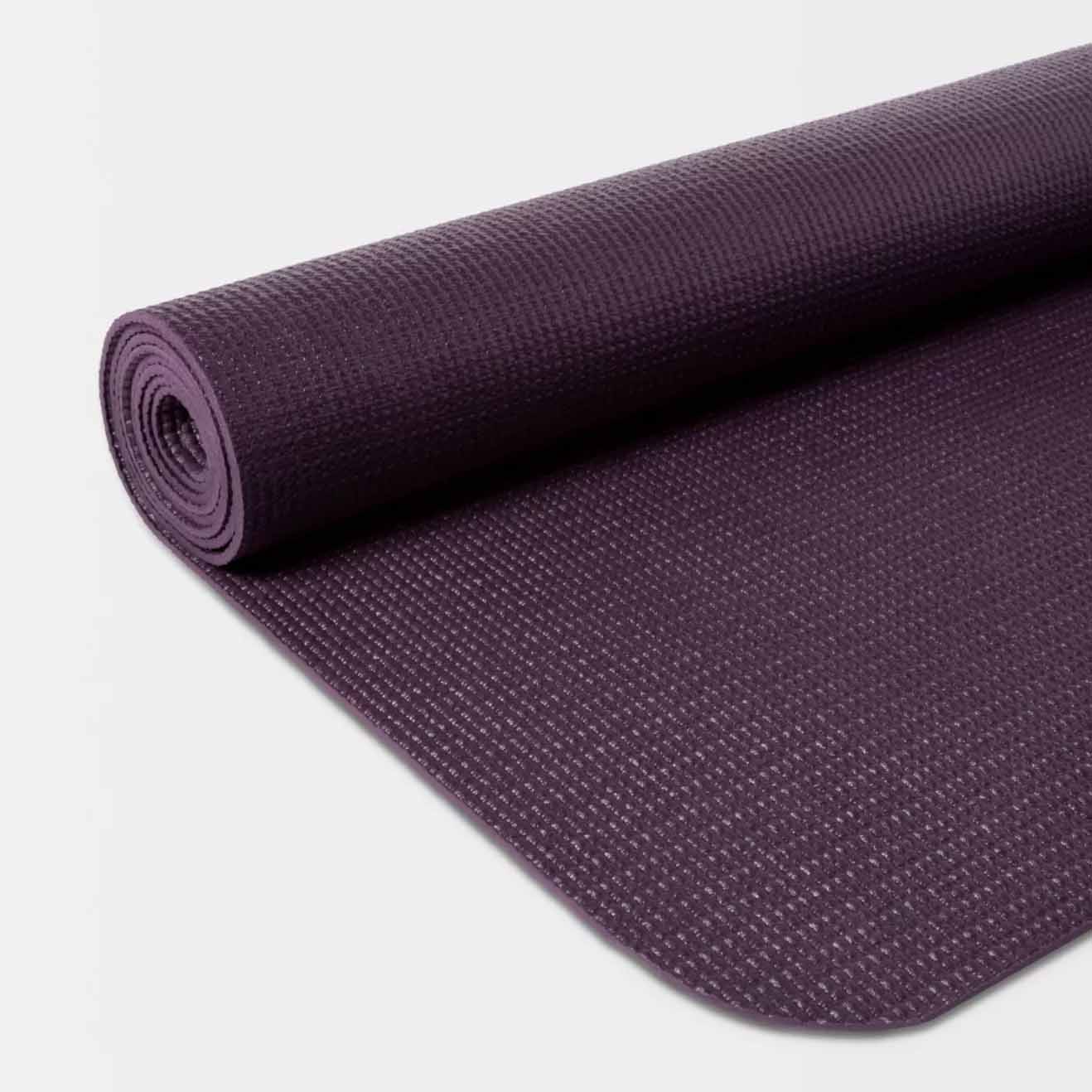 Close up of rolled dark purple yoga mat