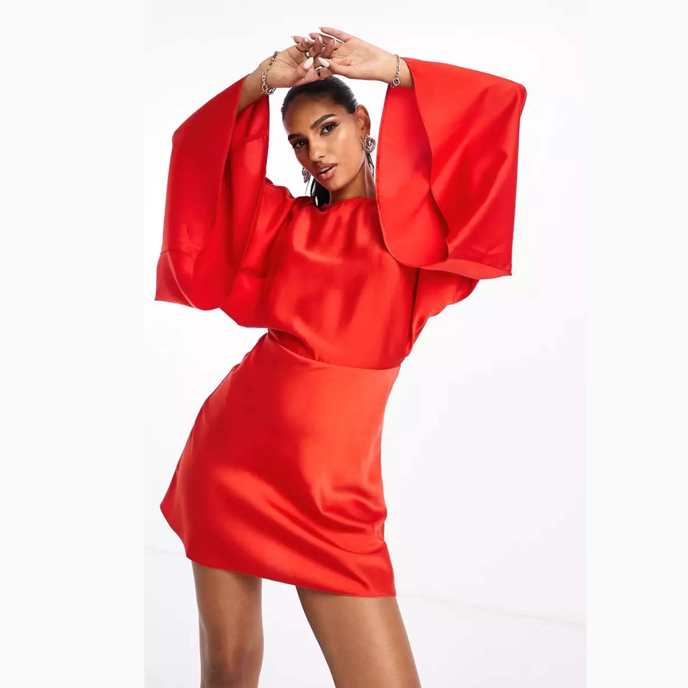 model wearing ASOS DESIGN Satin Batwing Sleeve Mini Dress in Red