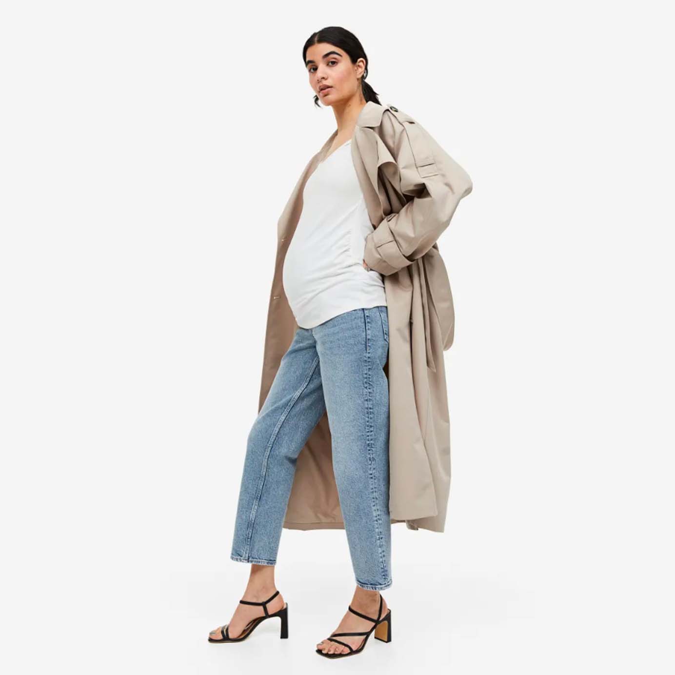 Model wearing straight cut maternity jeans and a trench coat