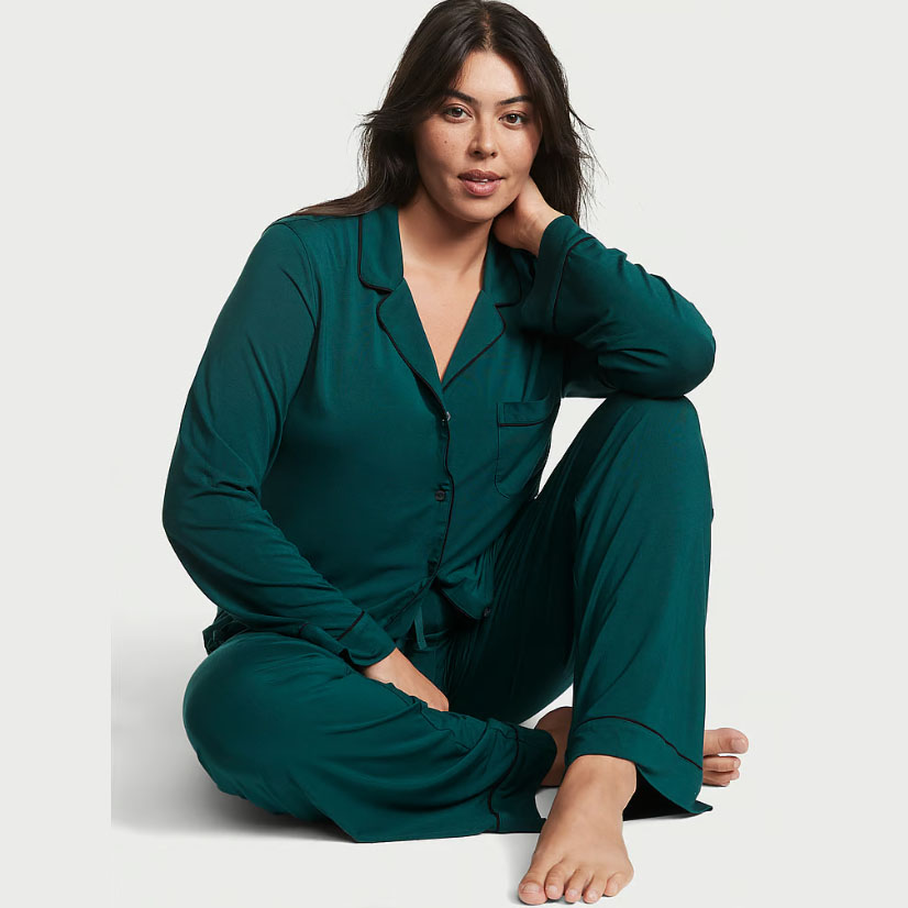 Model seated wearing Modal Long Pajama Set in dark green