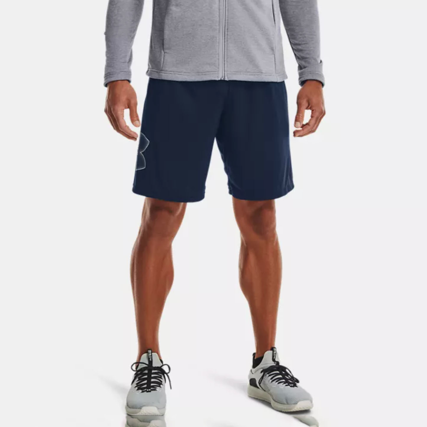 Men in grey sweatshirt and dark blue gym shorts