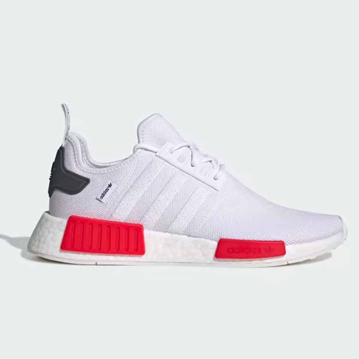 White Adidas NMD R1 with red accents against a white background