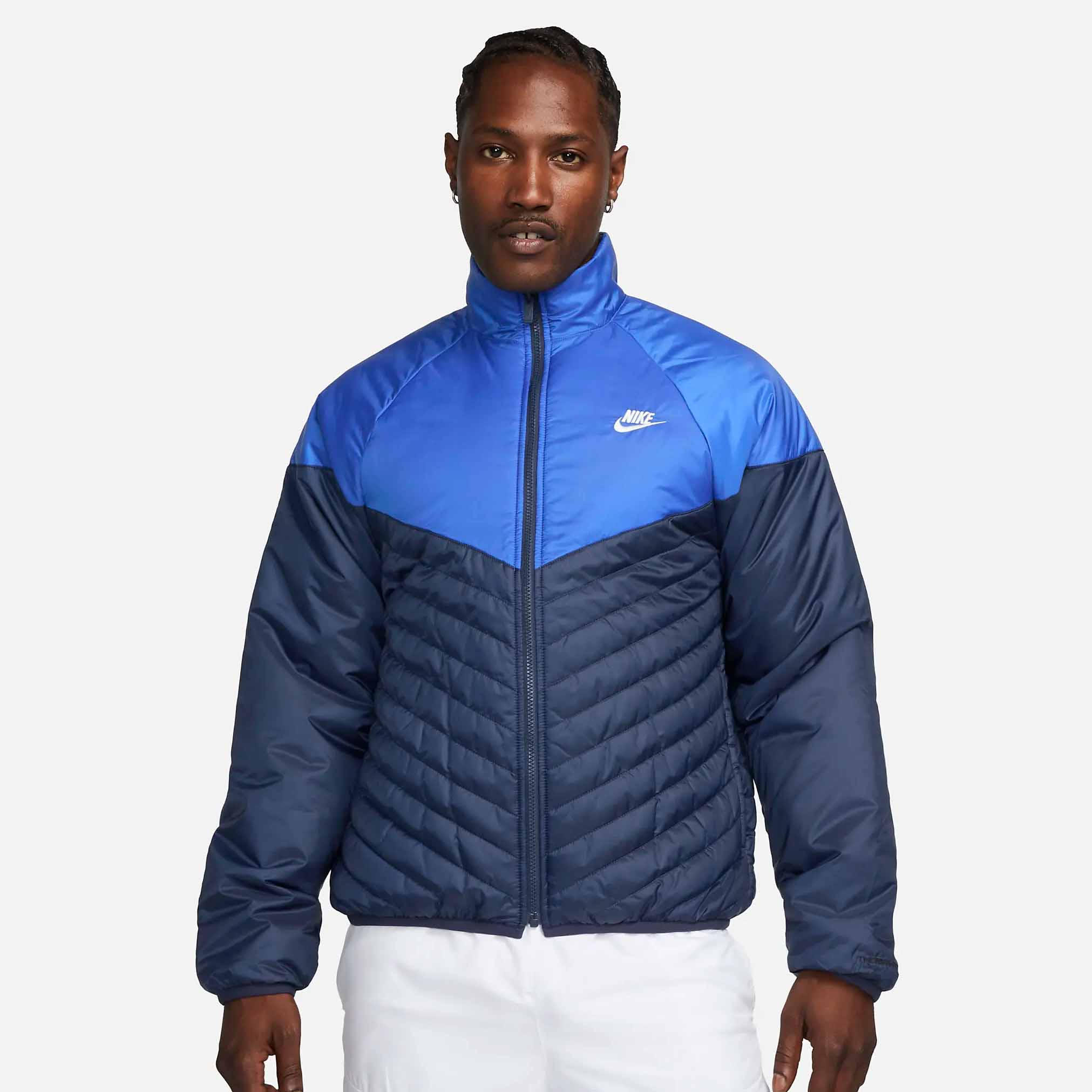 man wearing short Nike Sportswear Windrunner in two toned blue colorway