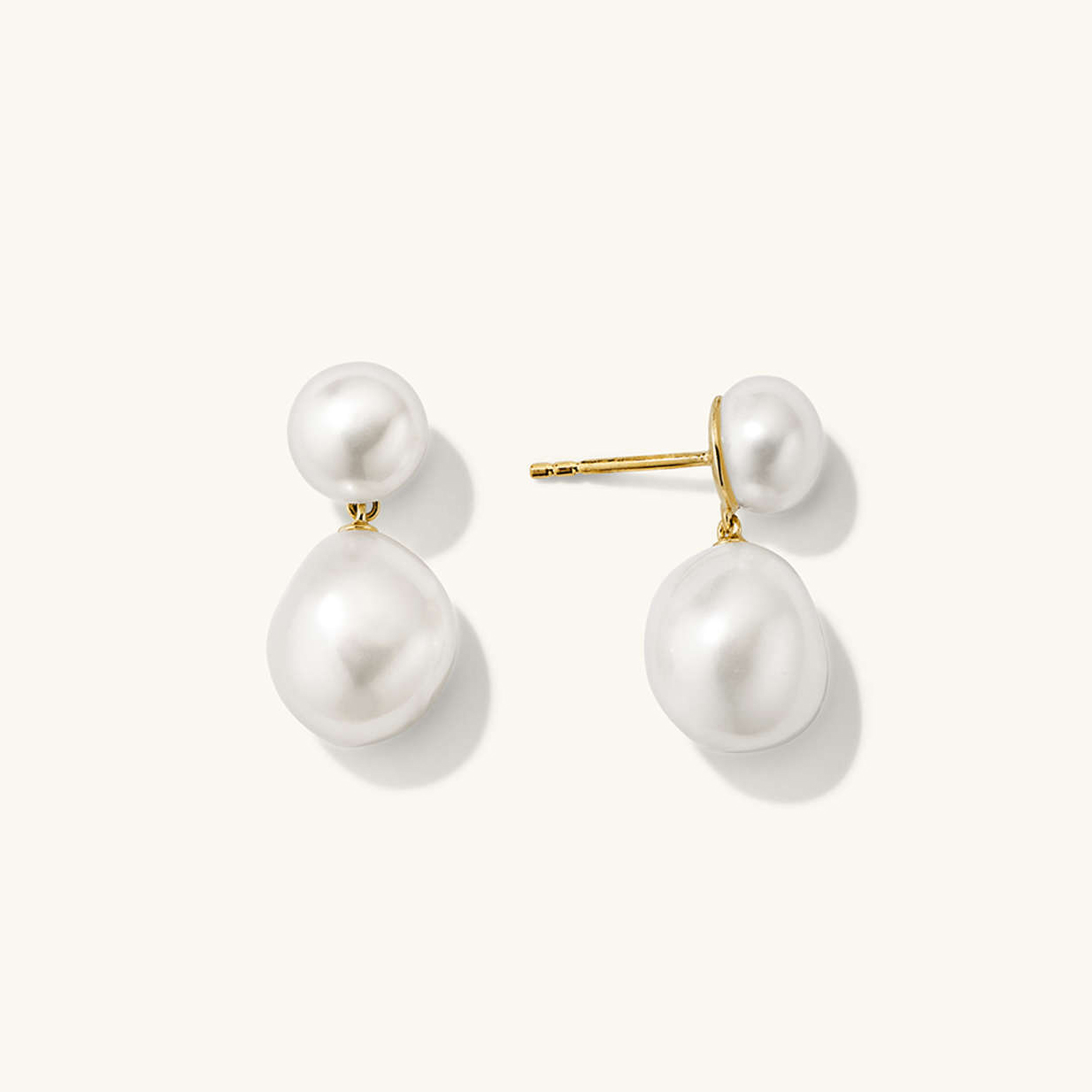 a pair of Mejuri white pearl drop earrings