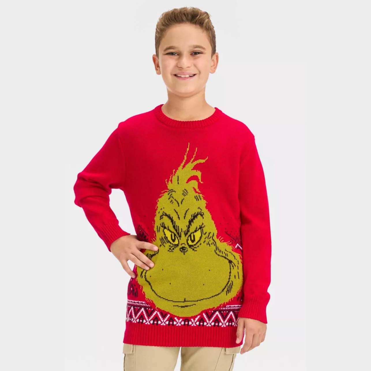 Boy wearing red The Grinch sweater