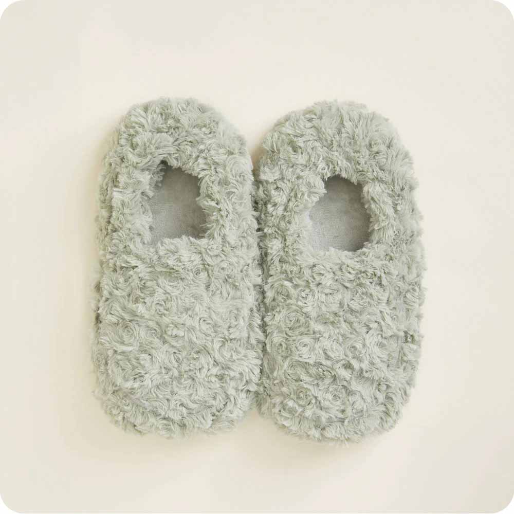 a pair of curly sage green warmies slippers
