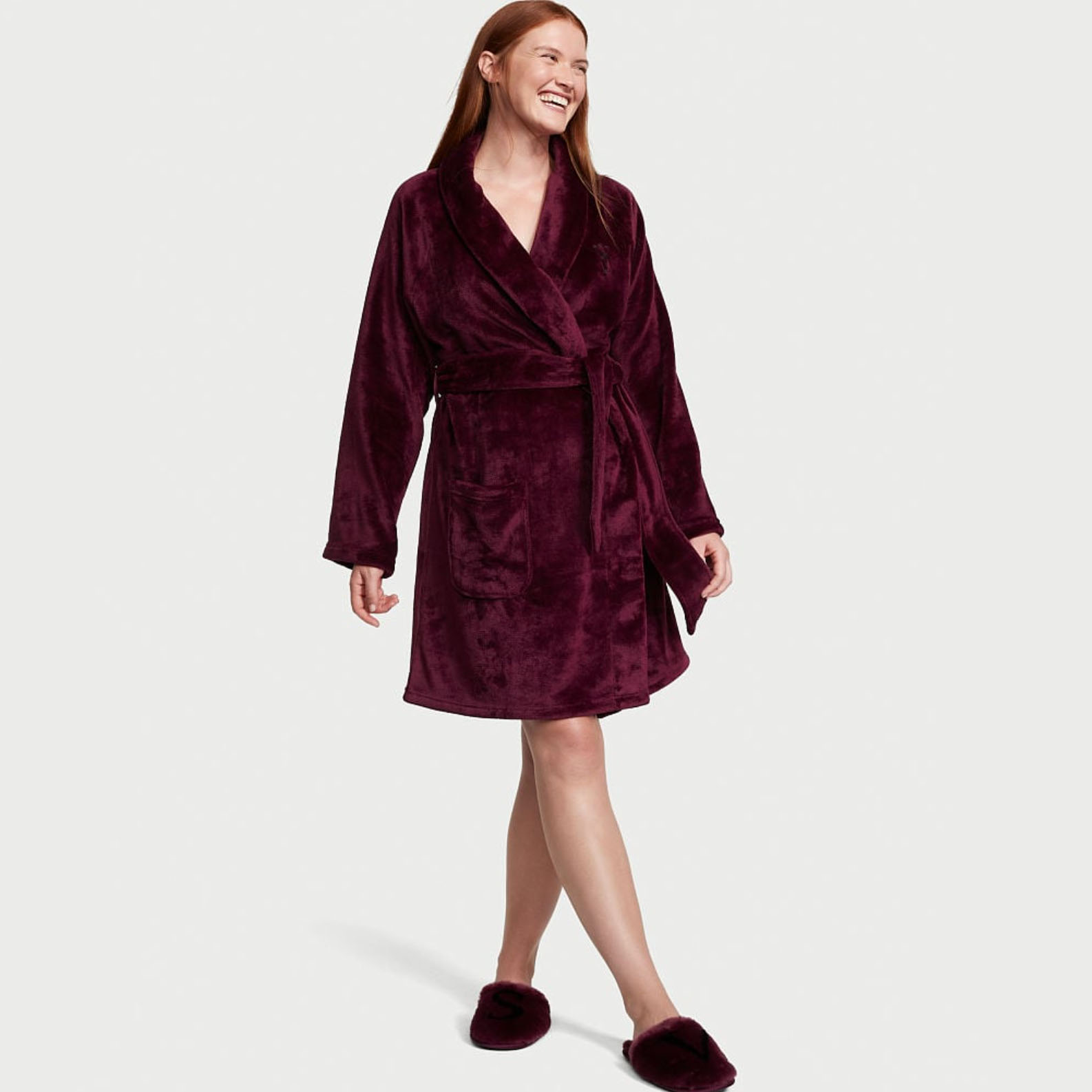Woman wearing fluffy maroon robe